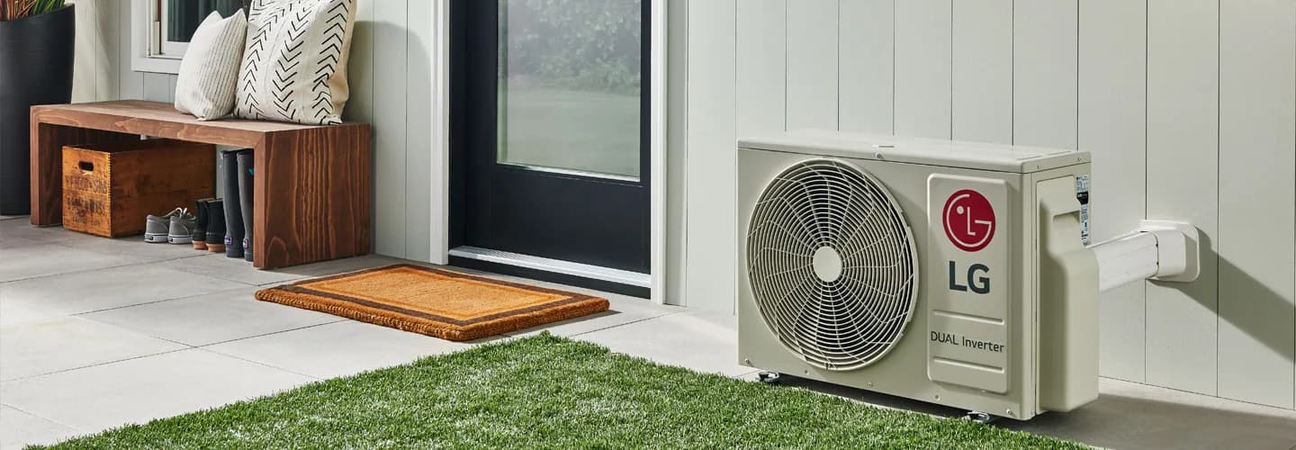 LG dual inverter heat pump outdoor unit installed beside a home entry