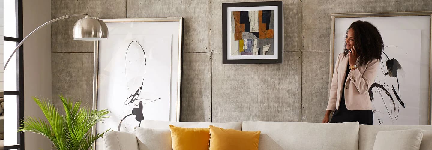 LG Art Cool Gallery indoor unit mounted like framed art in a living room