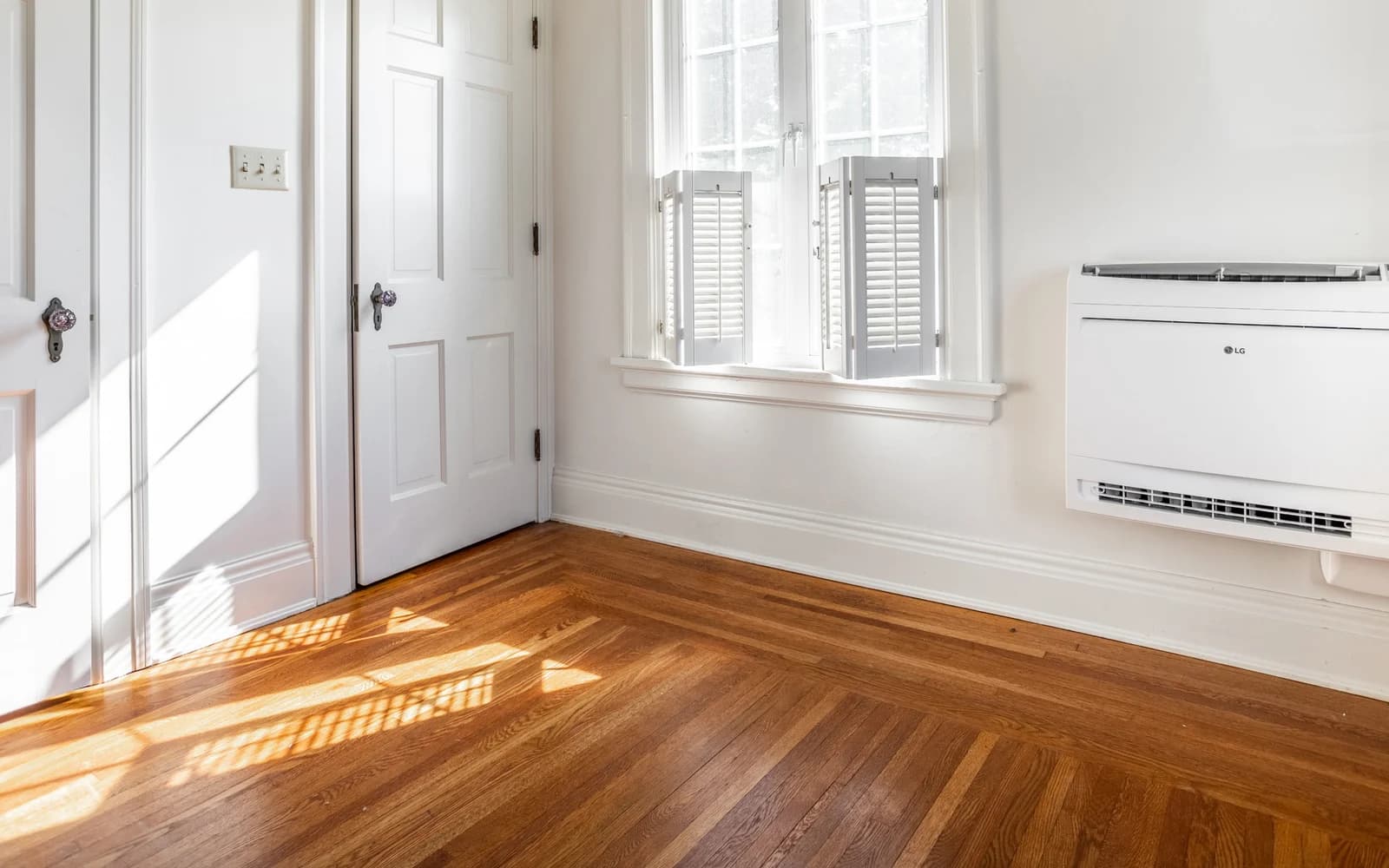Wall-mounted LG indoor heat pump unit in a bright room
